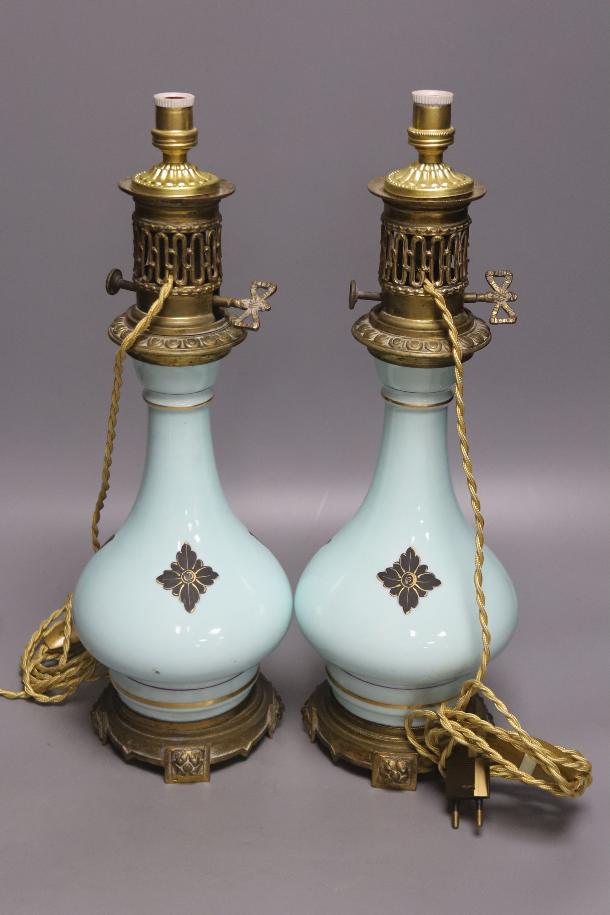 A pair of Napoleon III late 19th century porcelain and ormolu mounted oil lamps, height 40cm